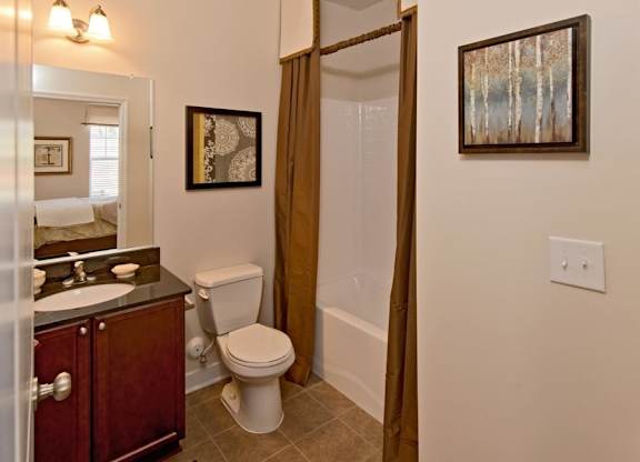 A bathroom with a toilet, sink, and shower.