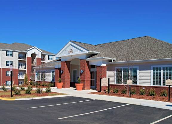 A building with a parking lot in front of it.