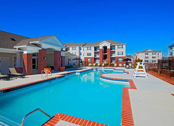 A swimming pool surrounded by a red brick border.
