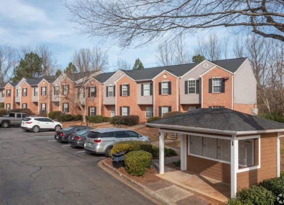 a row of apartment buildings with cars parked in a parking lot at Canaan Pointe, Greenville, South Carolina