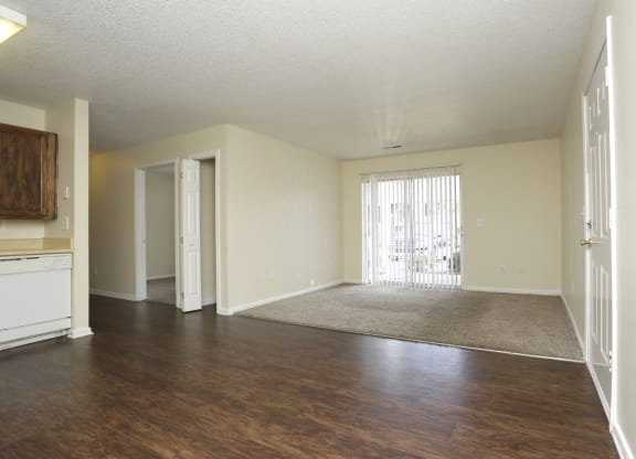 an empty living room with wood flooring and a door to a balcony at Canaan Pointe, Greenville South Carolina