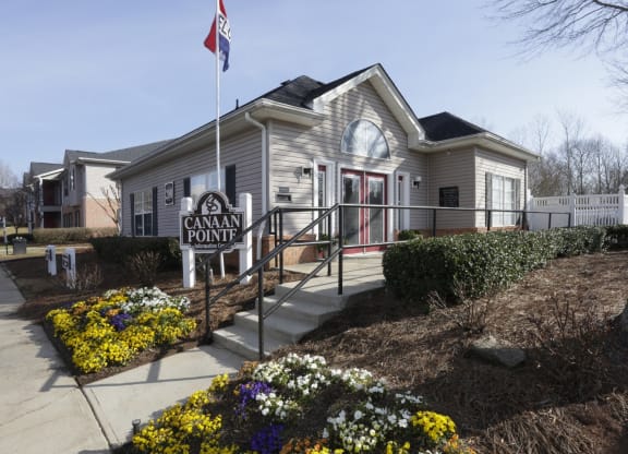 the front of a cream colored house with a flag and a sidewalk at Canaan Pointe, Greenville South Carolina