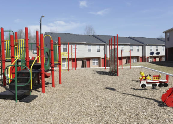 a playground with a wagon and houses in the background at Canaan Pointe, Greenville, 29607