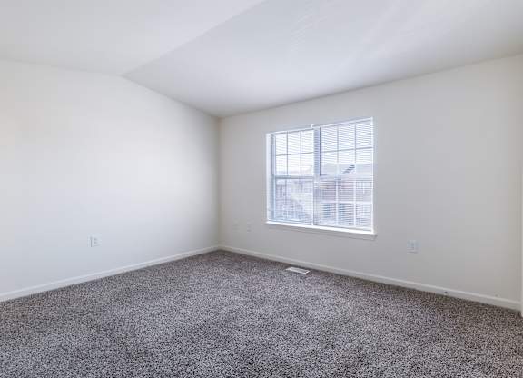 an empty room with carpet and a window at Crescent Pointe Townhomes, Stafford, VA 22554