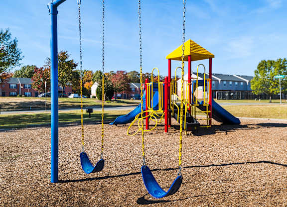 a playground with swings and a yellow swing set at Crescent Pointe Townhomes, Virginia, 22554