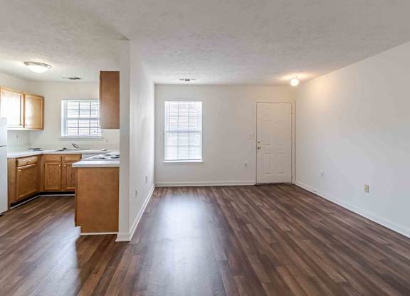 A room with wooden floors and white walls.
