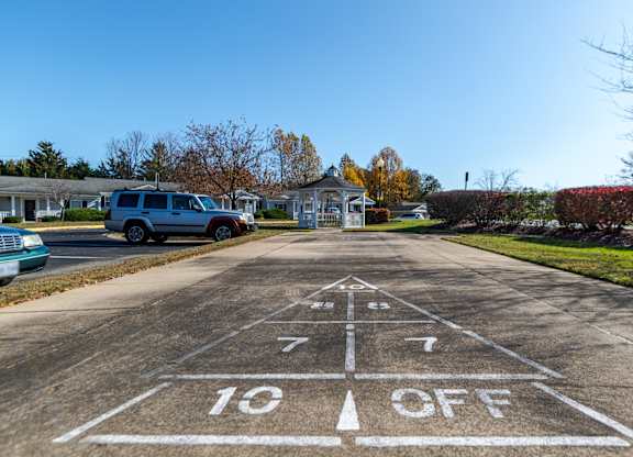 A parking lot with a white line painted on the pavement that says 10 off. at English Oaks Apartments, Fredericksburg, VA