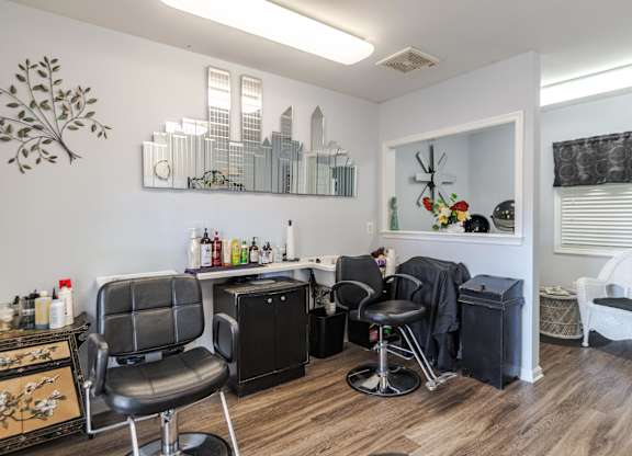 A room with a black chair and a white chair at English Oaks Apartments, Fredericksburg