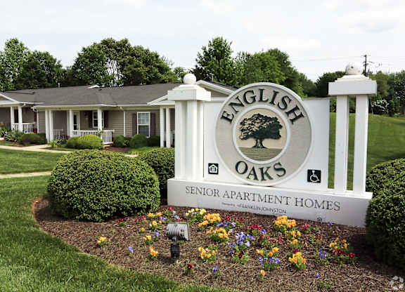 A sign for English Oaks Senior Apartment Homes in front of a building at English Oaks Apartments, Fredericksburg, Virginia