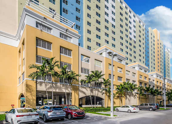 a large building with a parking lot in front of it