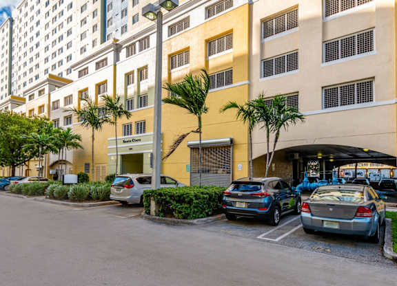 a large yellow building with a parking lot in front of it