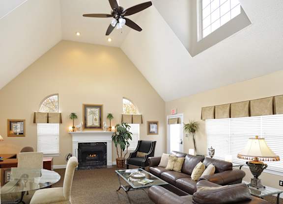 A living room with a fireplace and a ceiling fan.at Summerland Heights, Woodbridge, VA  