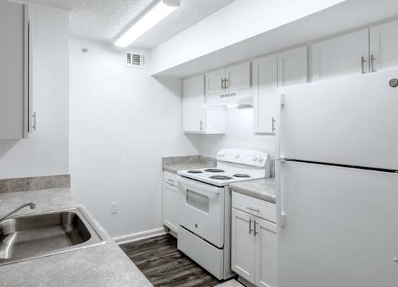 a kitchen with white appliances and white cabinets