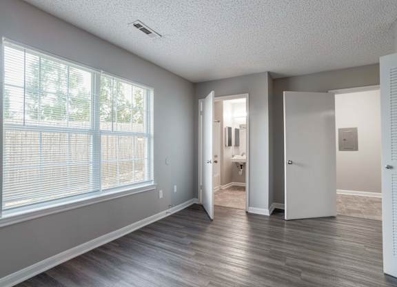 A room with a large window at Jamestown Pointe Apartments, South Carolina 