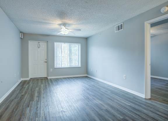 A room with a white door and a window with blinds.