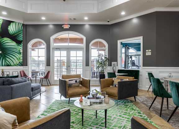 a resident clubhouse with couches chairs and a coffee table