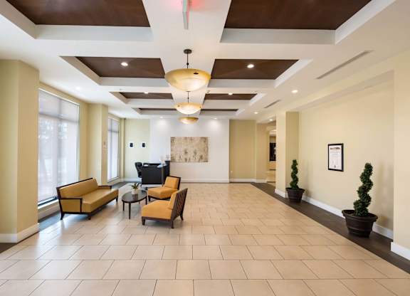 A spacious living room with a sofa set, a coffee table, and a television.