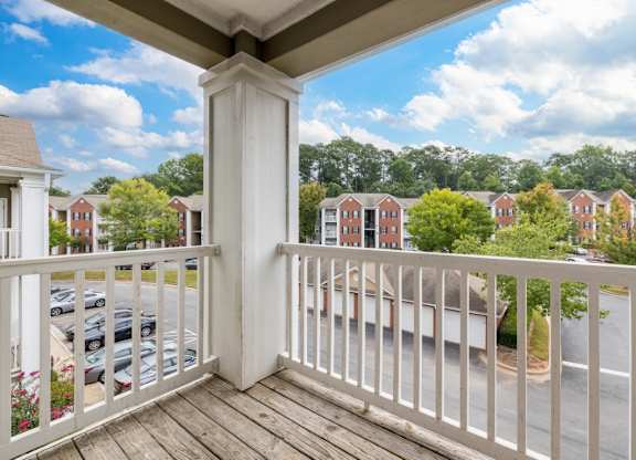 the view from the balcony of a home with a balcony railing at Magnolia Lake Apartments, Carrollton, GA