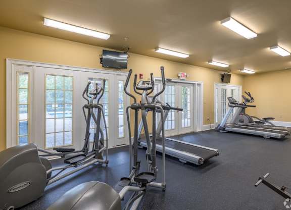 a gym with cardio equipment and windows at Magnolia Lake Apartments, Carrollton, 30117