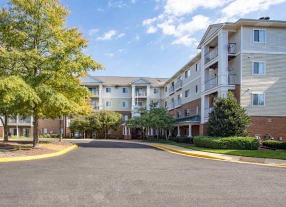 A large apartment complex with a flag flying in front of it.