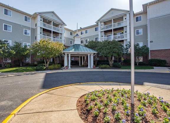 A building with a gazebo in the middle of a courtyard surrounded by apartment buildings.