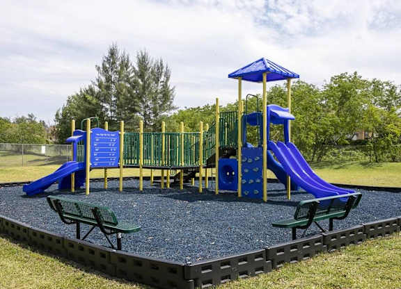 A playground with a blue slide and a yellow canopy.