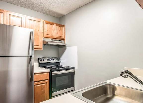 A kitchen with a stainless steel refrigerator, oven, and microwave.