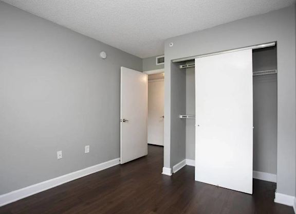 A room with a white door and a white closet door.