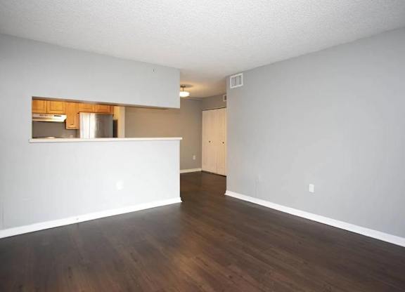 A room with wooden floors and white walls.