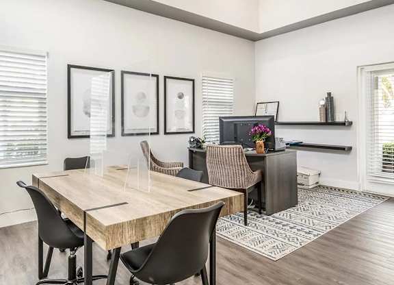 A dining room with a wooden table and chairs.