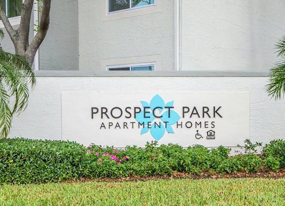 A white building with a sign that says Prospect Park Apartment Homes.