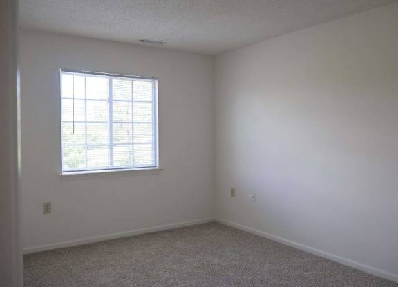 an empty room with a window and white walls at Greenbrier Seniors Apartments, Virginia, 23320