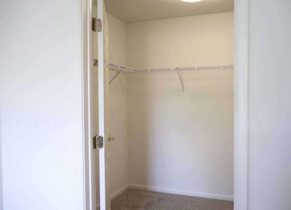 an empty closet with a white wall and a white door at Greenbrier Seniors Apartments, Chesapeake, VA 23320  