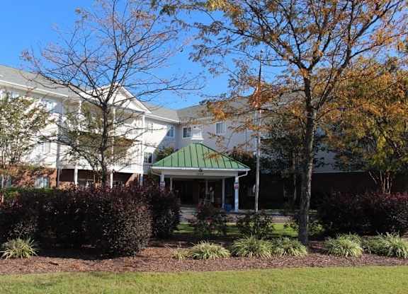 the front of a building with a green roof at Greenbrier Seniors Apartments, Chesapeake, VA 23320  