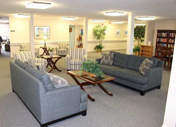 a living room with couches and chairs and a table at Greenbrier Seniors Apartments, Virginia, 23320