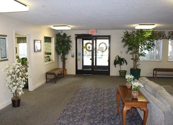 a living room with a couch and a coffee table at Greenbrier Seniors Apartments, Chesapeake, Virginia  