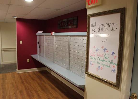 a locker room with a whiteboard and a message on the wall at Greenbrier Seniors Apartments, Chesapeake, VA 23320  