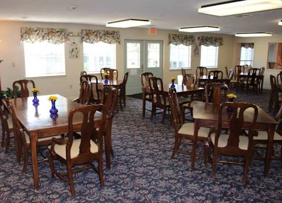 a large dining room with tables and chairs and windows at Greenbrier Seniors Apartments, Virginia, 23320