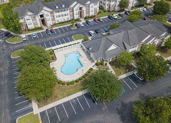 an aerial view of the resort style pool and hot tub at the enclave at woodbridge apartments at Palms on Ashley River Apartments, Ladson, South Carolina