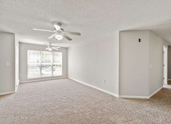 an empty living room with a ceiling fan at Palms on Ashley River Apartments, South Carolina 29456