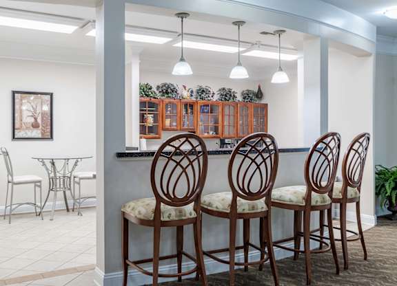A dining room with a table and chairs.