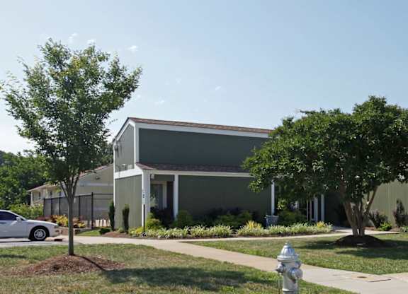 a gray building with a white fire hydrant in front of it