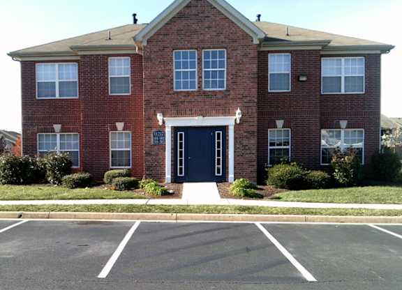 A red brick building with a black door and windows.