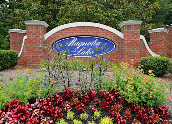 the sign is in front of a brick garden at Magnolia Lake Apartments, Georgia 30117