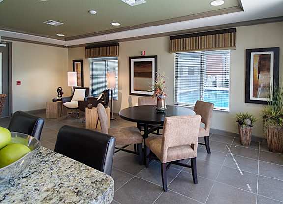 a dining room and living room with a table and chairs