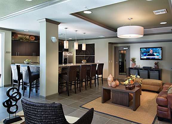 a large living room with a kitchen and a television