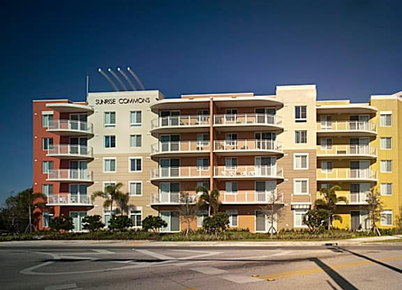 a rendering of an apartment building on the corner of a street