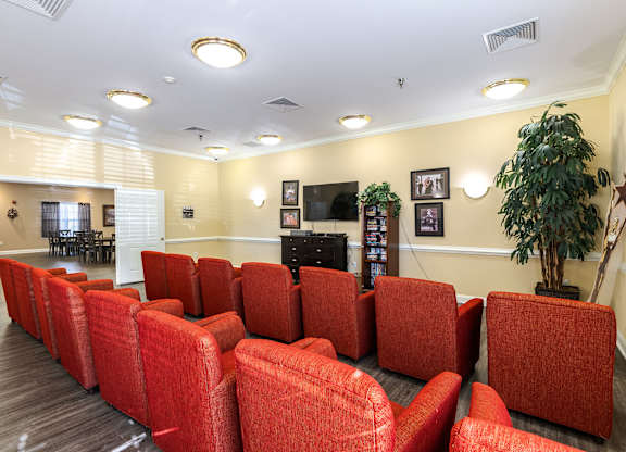 A row of red chairs are lined up in a room.at The Gardens of Stafford, Stafford, VA 22556  