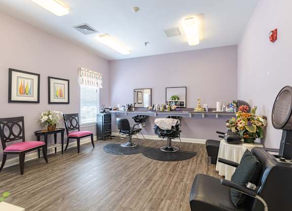 A hair salon with chairs and a mirror.at The Gardens of Stafford, Stafford, Virginia  
