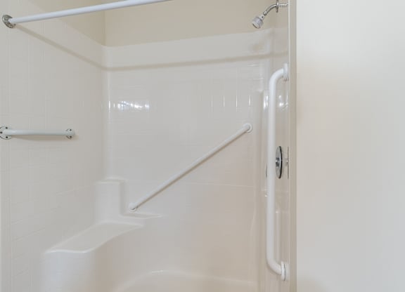 A white bathroom with a walk in shower.at The Gardens of Stafford, Stafford, Virginia  